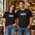 Man and woman in a restaurant wearing black Chef Diablo In the Weeds t-shirts