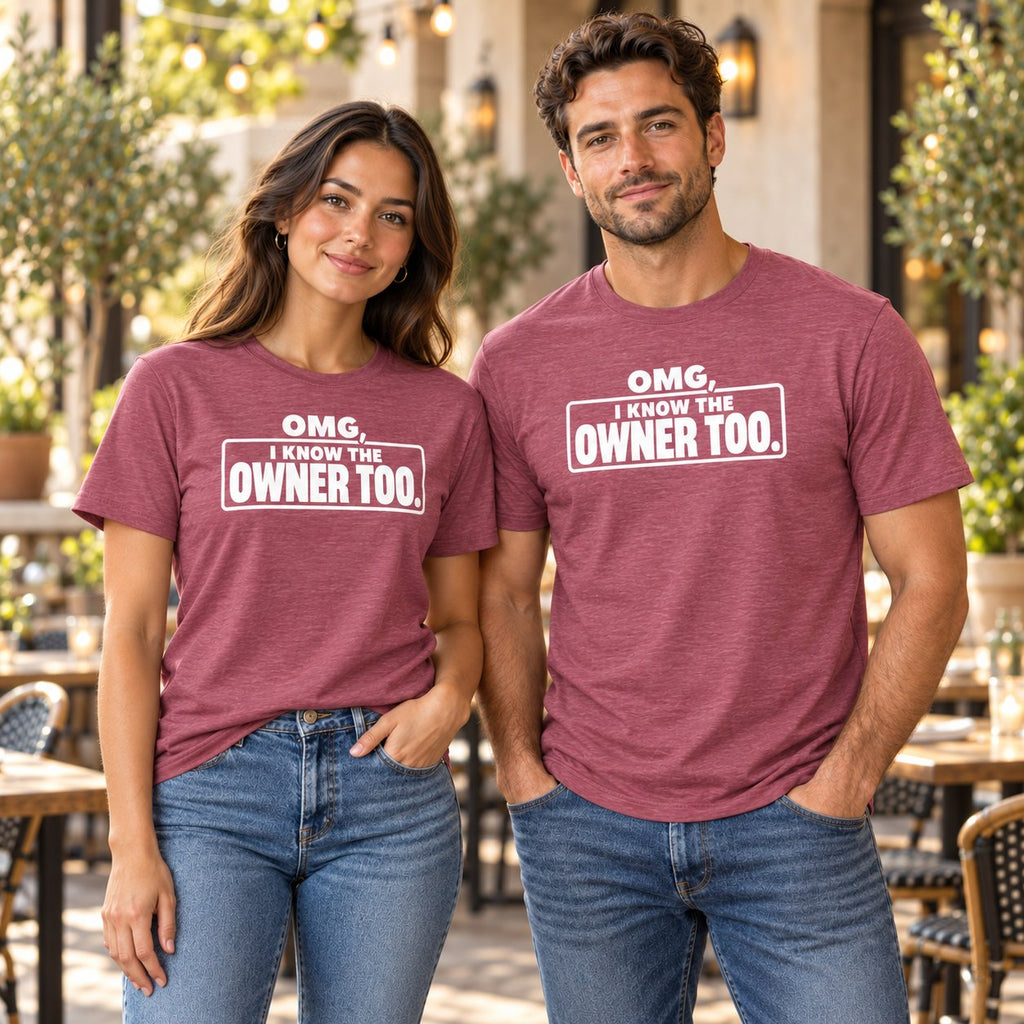 Man and woman on a restaurant patio wearing heathered pink Chef Diablo OMG, I Know the Owner Too t-shirts