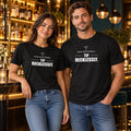 Man and woman at a cocktail bar wearing black Chef Diablo Drink Responsibly, Tip Recklessly t-shirts